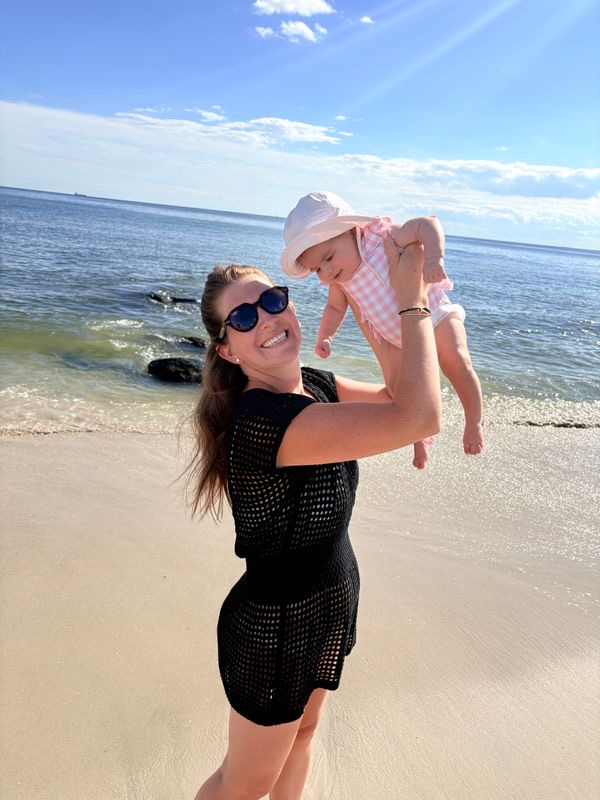 Carly Grossinger holding her baby on the beach